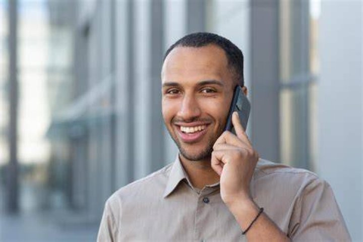 A man smiling at phone | Source: Shutterstock