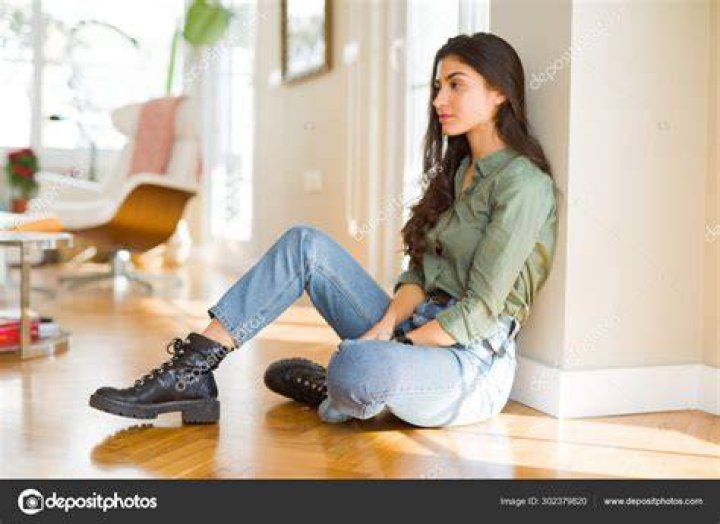 A woman sitting on a couch while having a disagreement with her mother-in-law | Source: Shutterstock
