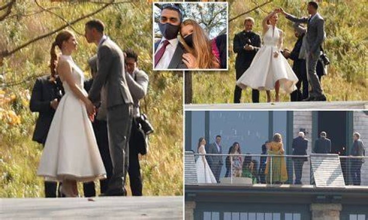 Beaming bride Jennifer Gates and her dashing groom stepped out on the deck of their home to enjoy a quiet moment on Friday with her recently divorced parents Bill and Melinda Gates, and her little brother