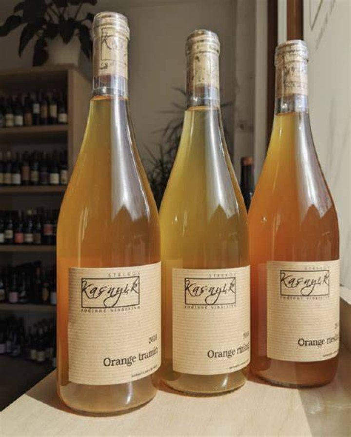 bottle of wine with orange label on a white background 