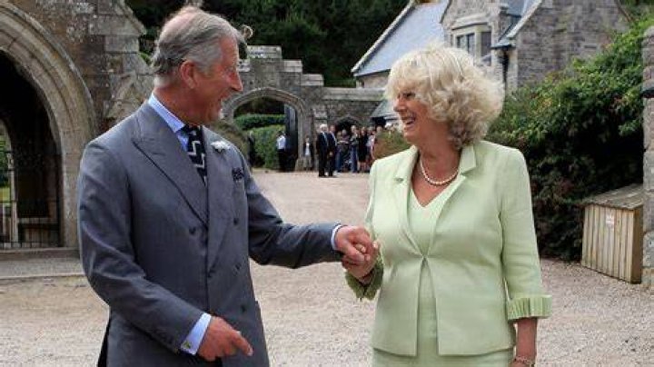 Charles and Camilla holding order of service