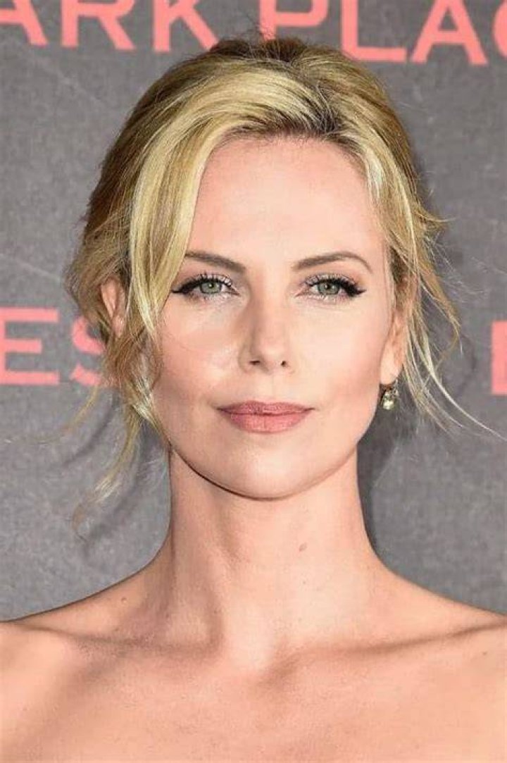 Charlize Theron is a goddess in pink silk Dior gown as she steps out on Oscars 2024 red carpet