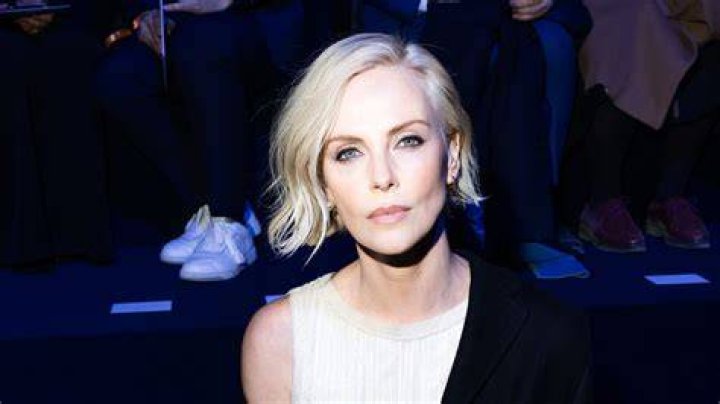 Charlize Theron soaks up the sun in a swimsuit on beach getaway