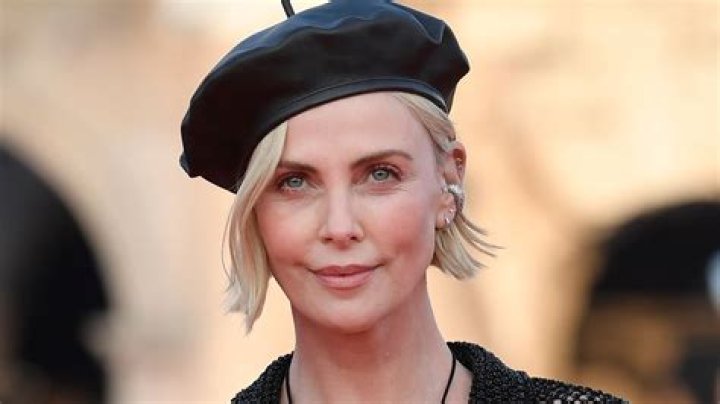 Charlize Theron stuns in swimsuit under see-through mesh dress teasing 'something cheeky'