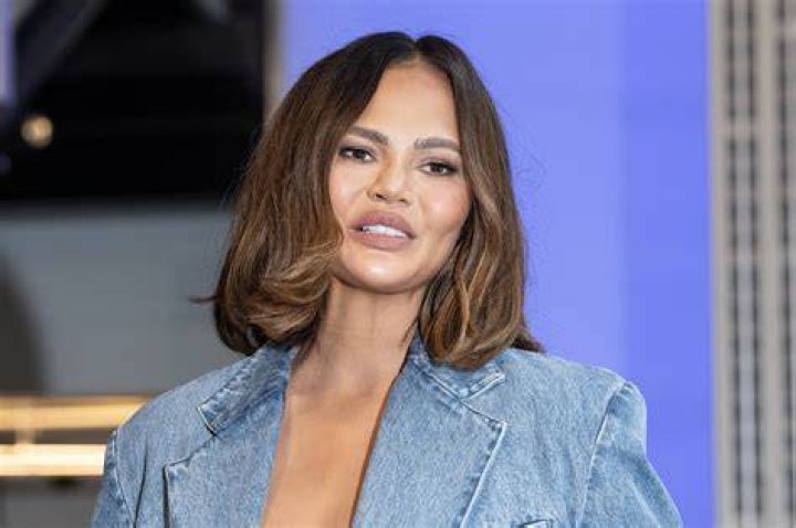 Chrissy Teigen unairbrushed bikini photo in black swimwear with baby son Wren