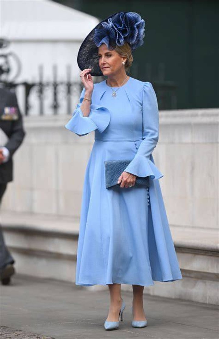 Duchess of Edinburgh in blue coat with white fitted coat and brown suede boots and bag