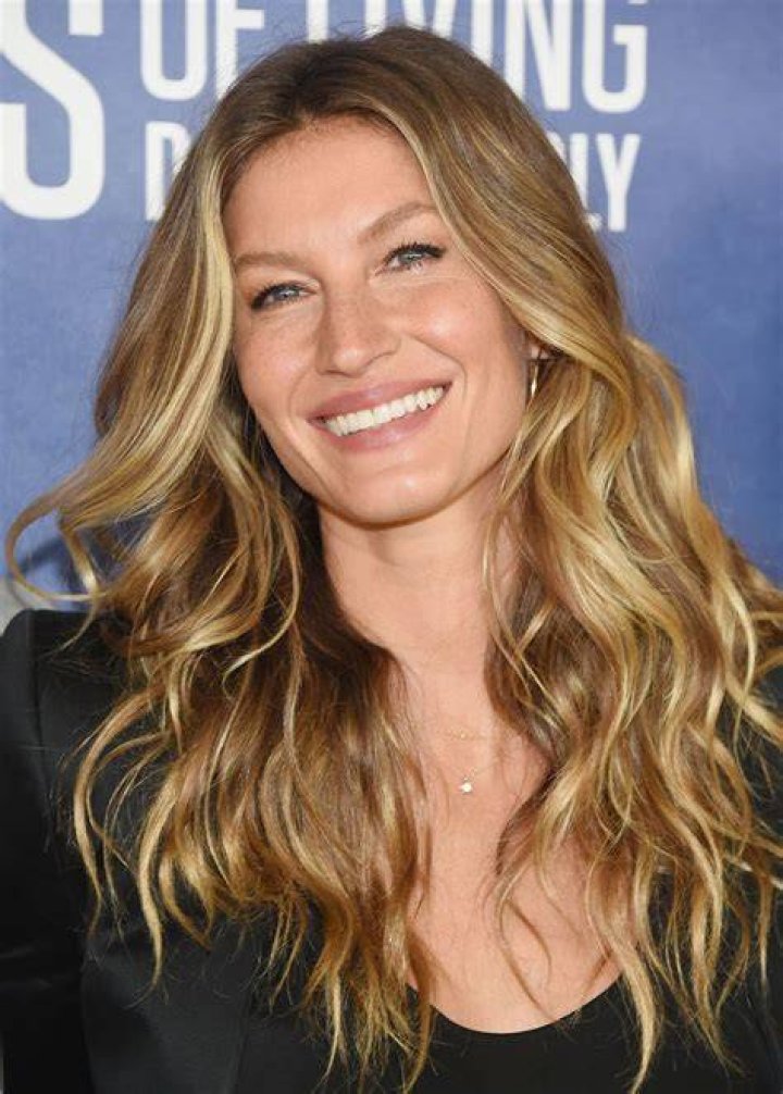 Gisele Bundchen smiling in suit
