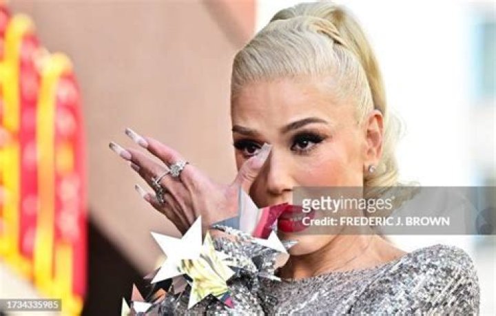 Gwen Stefani wipes tears from her eyes during her Hollywood Walk of Fame Star ceremony in Hollywood, California, on October 19, 2023. | Source: Getty Images