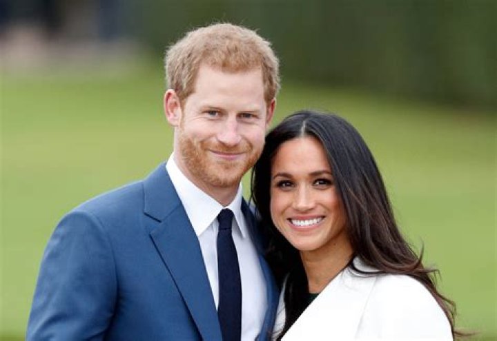 Harry and Meghan smiling at Invictus Games