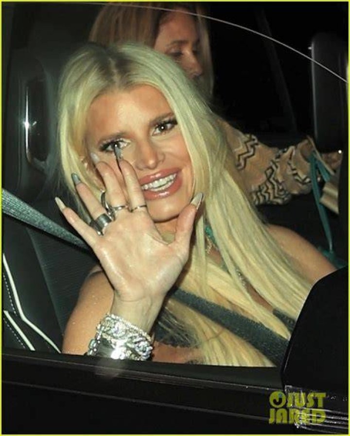 Jessica Simpson smiles as she wears her cheerleading jacket from the eighth grade