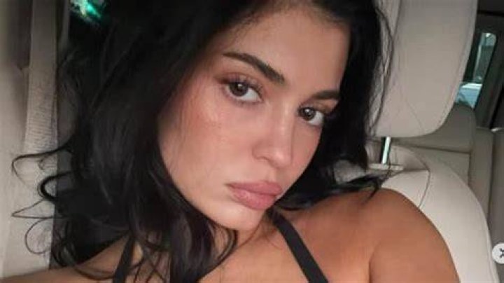 Kendall Jenner almost busts out of a tiny black bikini