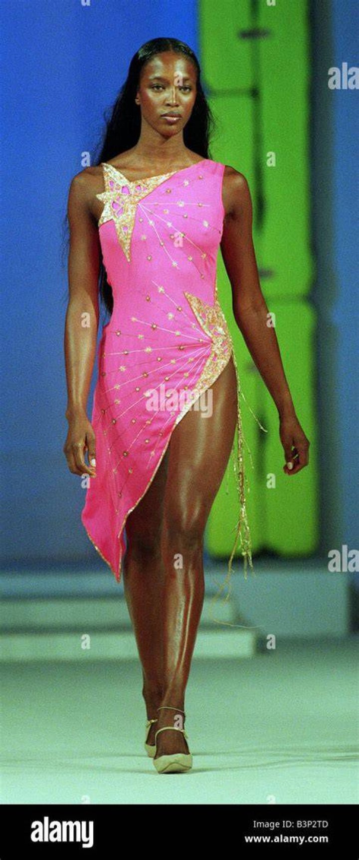 Naomi Campbell wearing a pink mini dress and matching jacket with a black and white chain belt in Chanel's Ready to Wear Spring/Summer 1993-1994 show