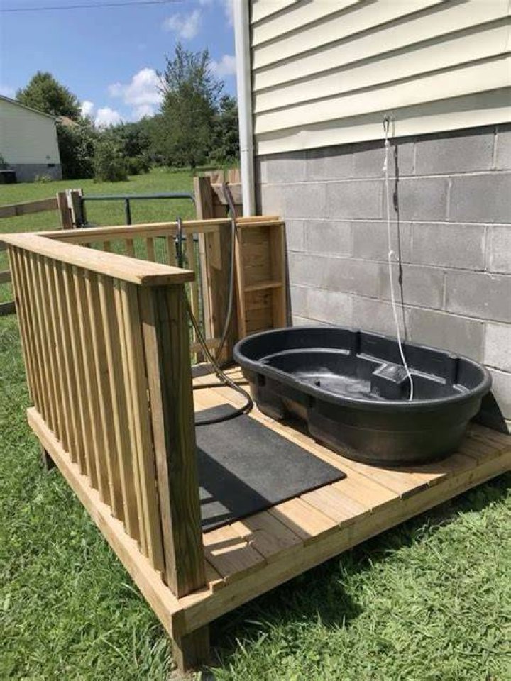 Outside dog bath appended to a stone wall