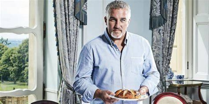 Paul hollywood standing next to white car 