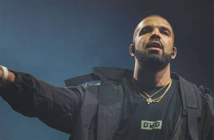 Photo shared by Drake on Instagram December 2023 posing inside his Toronto home with his mom Sandi Graham and his son Adonis, six