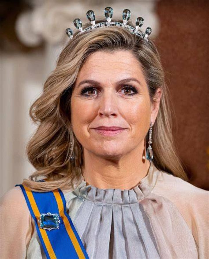 Queen Maxima of The Netherlands arriving at the social restaurant 'A Beautiful Mess' in red dress and hat