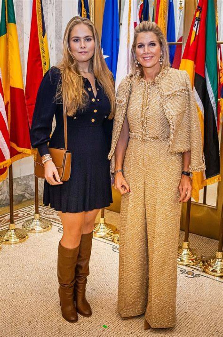 Queen Maxima standing in line up of people