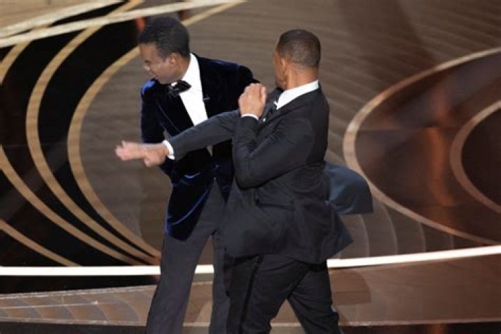 Reasoning: The Oscars slapping incident was prompted by Rock making a joke about Smith's wife, Jada Pinkett Smith, about how she kept her head shaved; the actors are seen during the 2022 ceremony