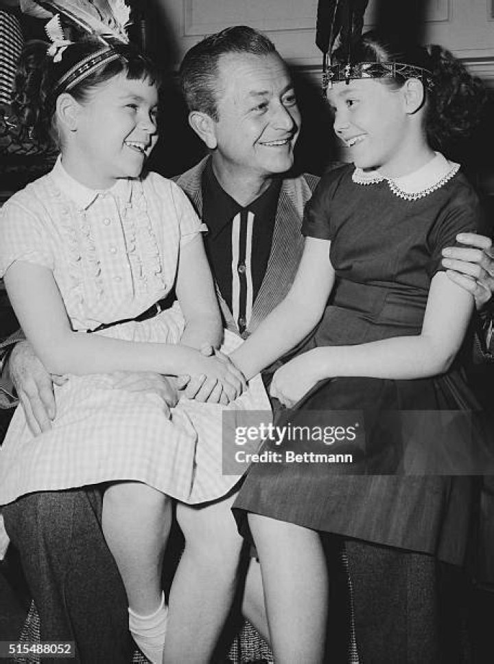 Robert Young introduces one of his five real daughters, Kathy Young, to his daughter, Kathy played by Lauren Chapin, from the series "Father Knows Best" on February 13, 1956 | Source: Getty Images
