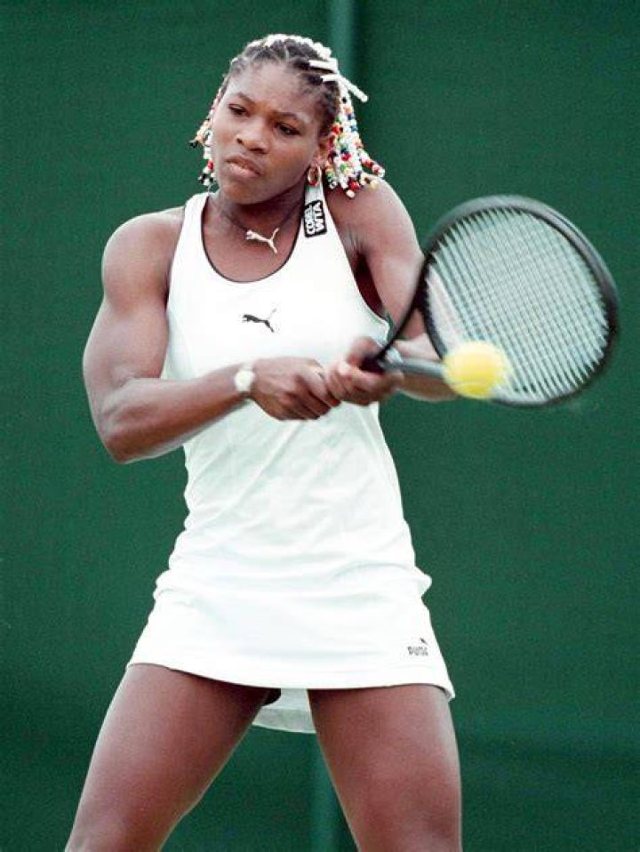 Serena Williams and a young girl on the beach, the young girl is jumping into the air