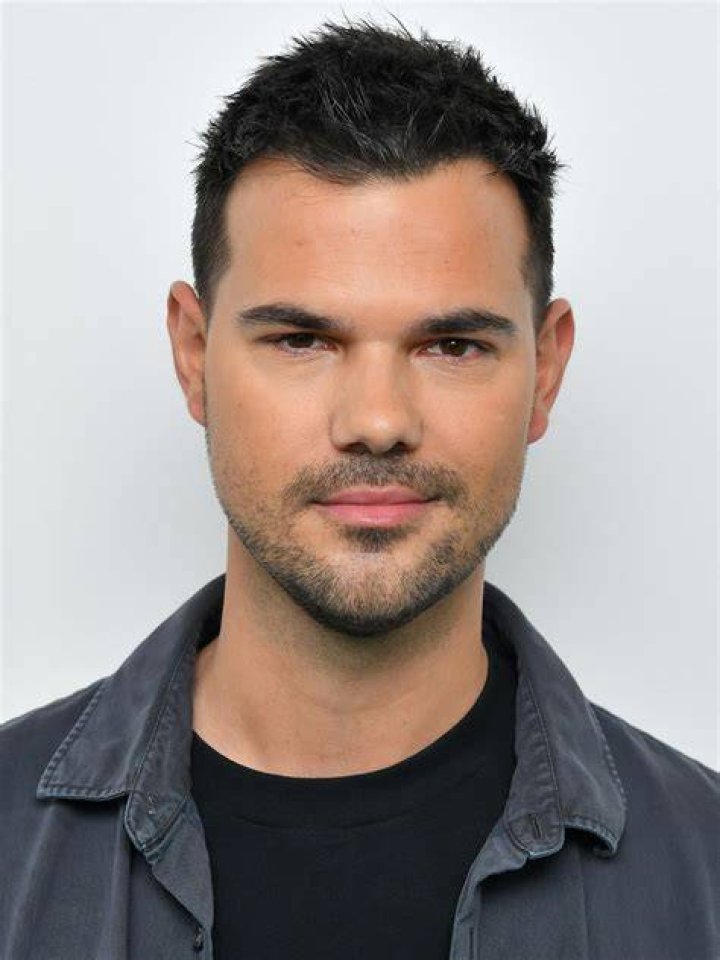Taylor Lautner in a green shirt