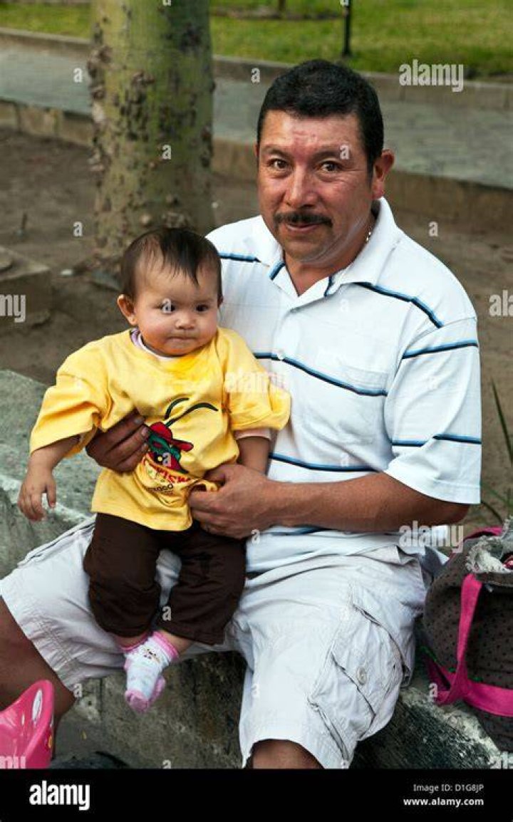 The Mexican father puts his hands on his chest in surprise while his daughter stares at her mother sitting by their side. | Source: 