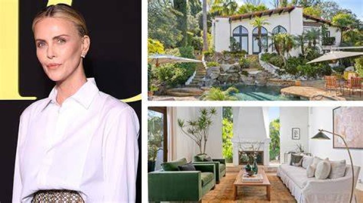 Where does Charlize Theron live with her adopted daughters?