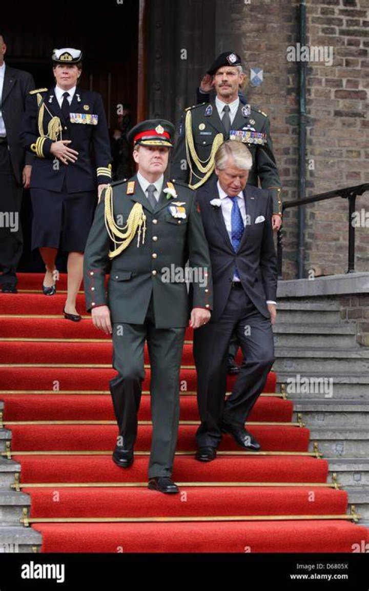 Willem Alexander in a military uniform linking arms with his new bride Maxima on their wedding day in 2002
