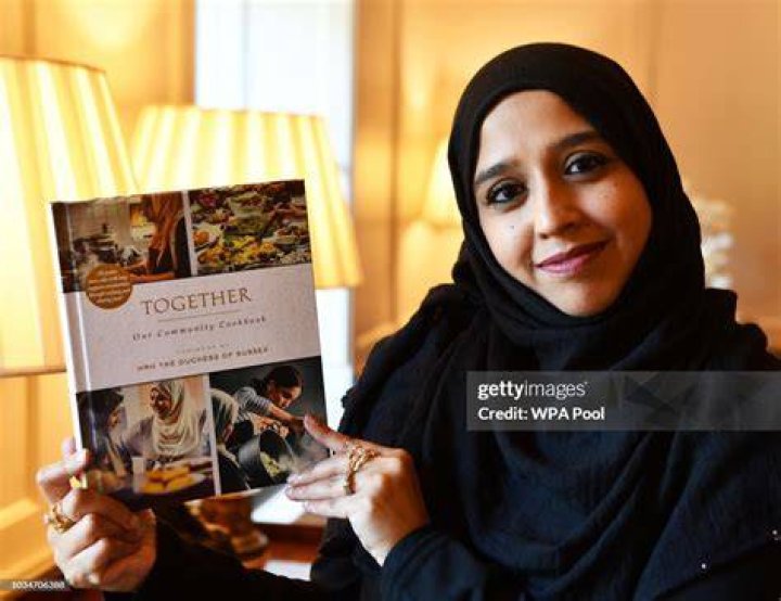 Zahira Ghaswala hols a copy of 'Together' a book that tells how women came together after the Grenfell Tower tragedy to cook for the local community, which has a foreword by the Duchess of Sussex at Kensington Palace. | Photo: Getty Images