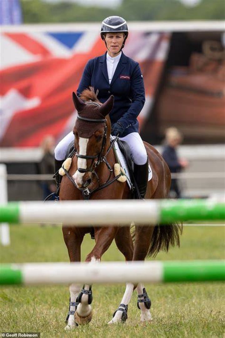 Zara Tindall riding a horse while Mike Tindall watches on